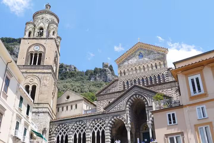 The stunning Amalfi Cathedral with its intricate facade towers over the charming town, a must-see on the Naples tour.