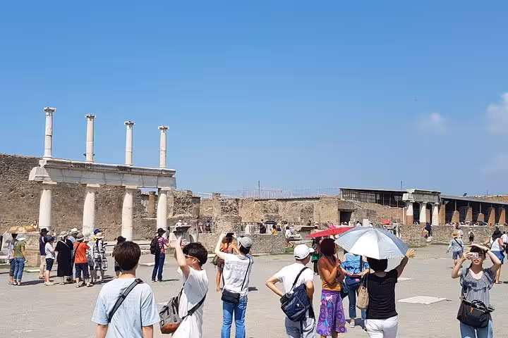 Tourists exploring Pompeii ruins on a private 6-day Amalfi Coast, Sorrento, Positano and Capri tour from Rome