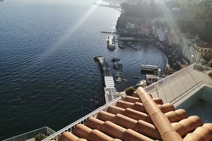 Panoramic view from clifftop terrace over Amalfi Coast marina and boats, featured on shared tour Ravello Amalfi Positano