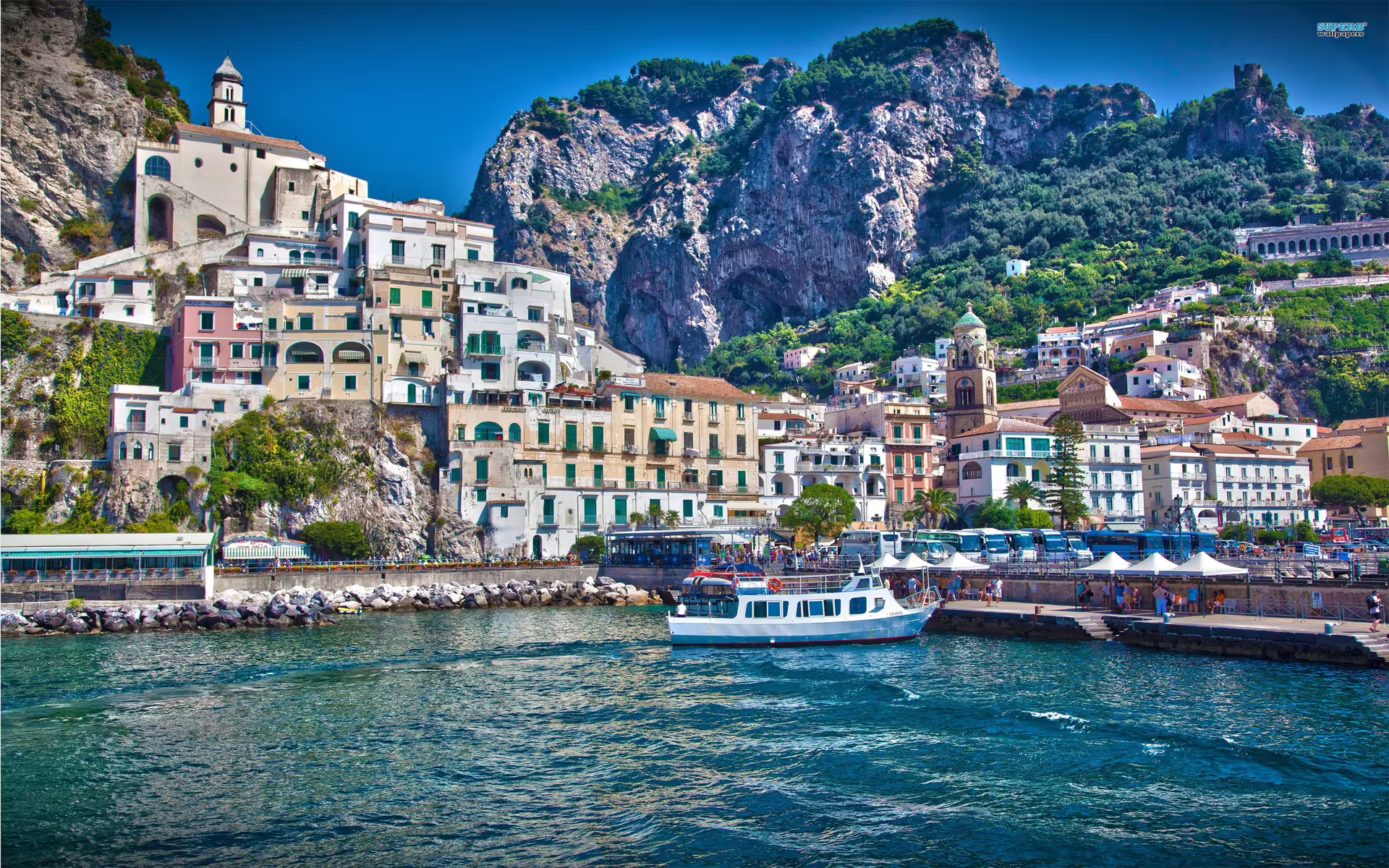 Amalfi Coast harbor with colorful cliffside town and boat views, included on Pompeii & Amalfi from Naples low cost tour