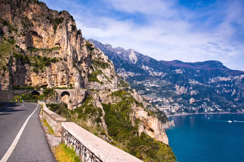 Breathtaking coastal road with rocky cliffs and sea views on the Amalfi Coast minivan tour.