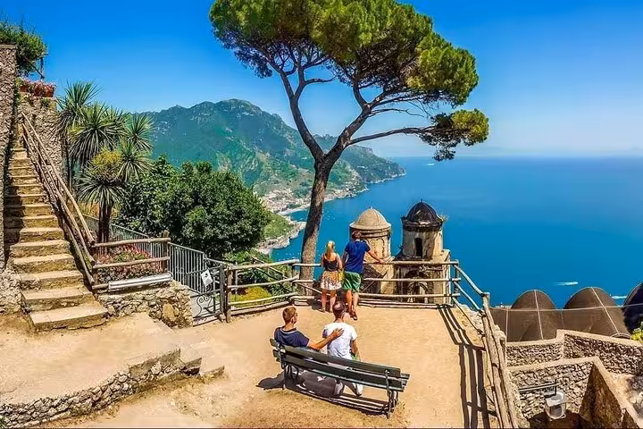 Tourists enjoy breathtaking views of the Amalfi Coast from a scenic terrace in Ravello, perfect for an unforgettable Naples day trip.