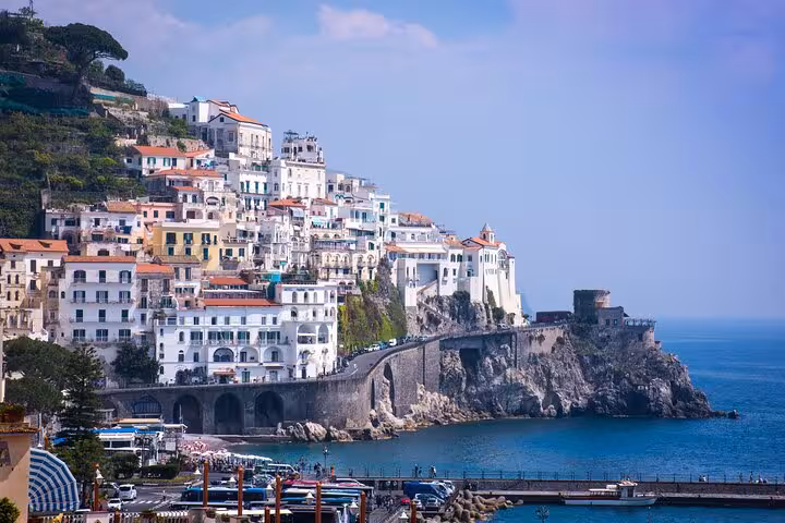 Stunning Amalfi coastline with colorful cliffside buildings overlooking the serene blue Mediterranean Sea.