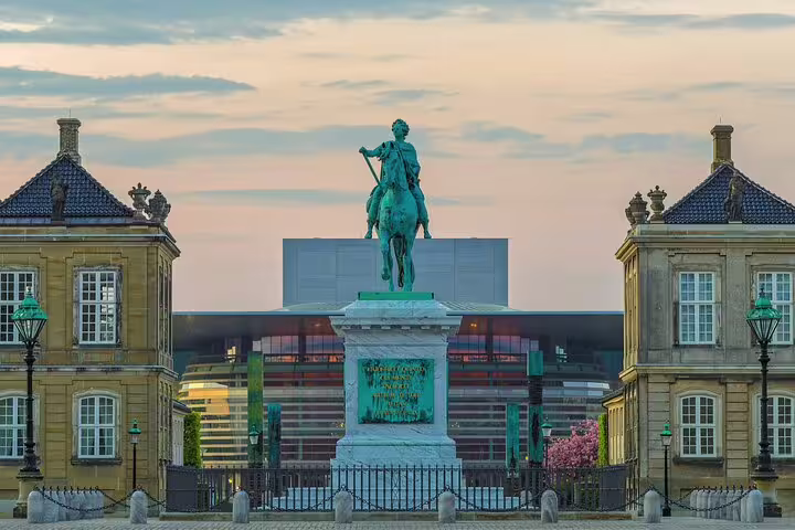 Equestrian statue in Amalienborg Square, Copenhagen, with the Opera House in the background, featured on a private walking tour.