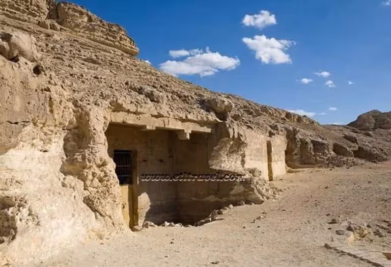 Rock-cut tomb entrance at Amarna desert cliffs, a highlight of the 2-day Amarna Beni Hassan Dendera Abydos tour