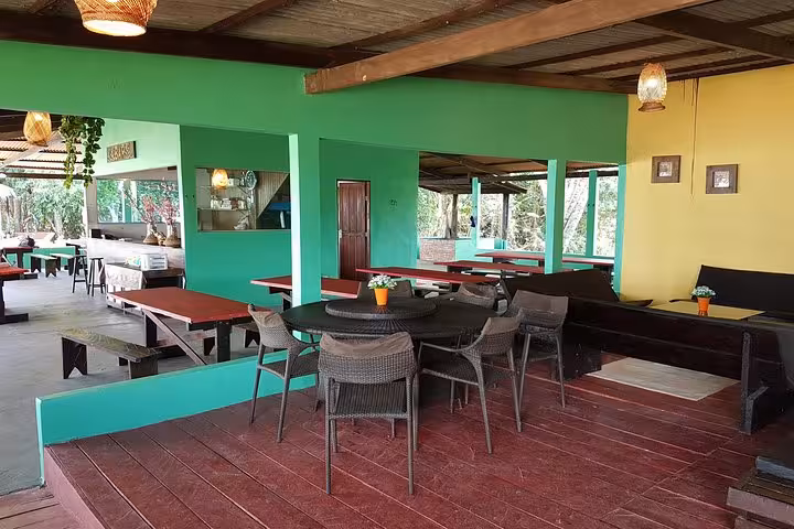 Open-air Amazon jungle lodge dining area with tables and seating, included on 3-day Amazon rainforest tour