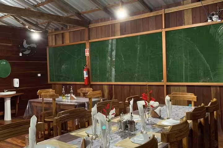 Cozy dining area with rustic wooden decor at Amazon Mamori Lodge, offering a unique jungle dining experience.