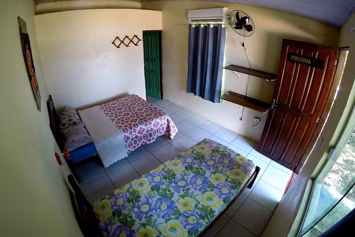 Simple Amazon jungle lodge twin room with air conditioning and fan, comfortable stay on a 5-day Amazon jungle adventure tour