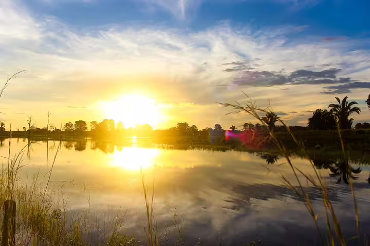 Stunning Amazon sunrise reflecting over tranquil waters, creating a serene start to the day at Amazon Mamori Lodge.