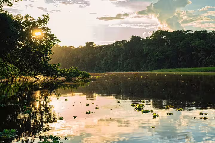 Breathtaking sunset over a tranquil river at Amazon Mamori Lodge, reflecting the lush Amazon Jungle landscape.