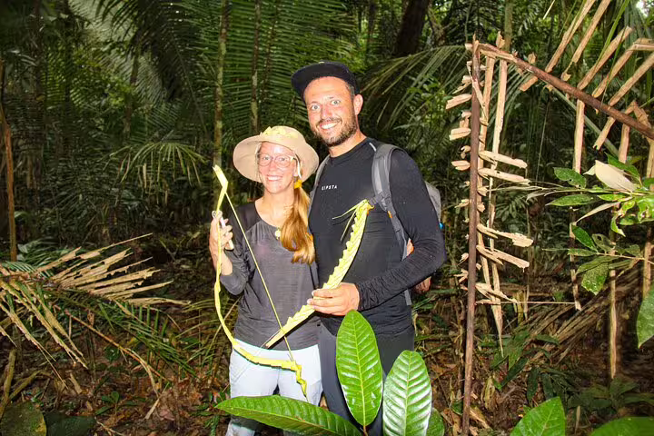 Smiling tourists exploring Amazon jungle with local vines at Amazon Mamori Lodge adventure.