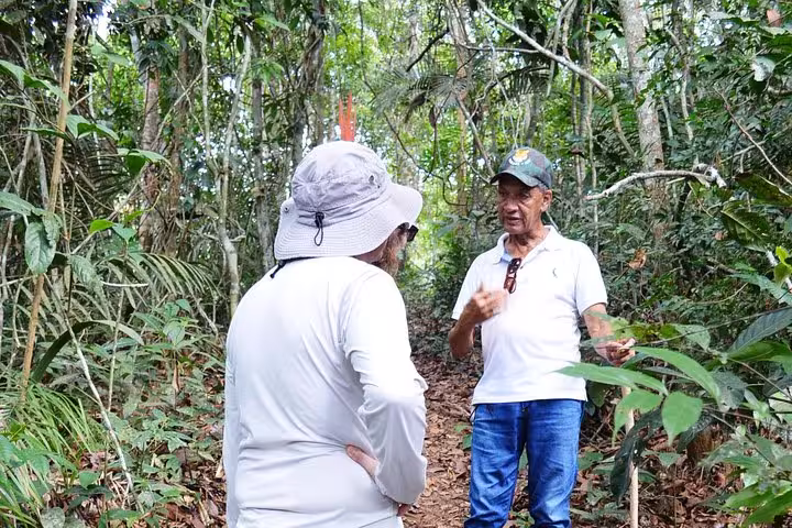 Local guide briefing hikers on an Amazon rainforest trail during a 4-hour trekking forest tour experience