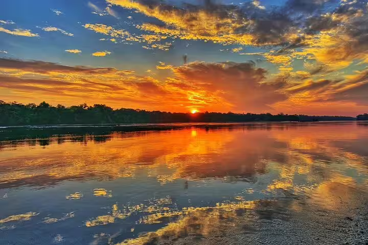 Stunning sunset over the Rio Negro reflecting vibrant hues, perfect for Amazon Adventure Trip at Tapiri Rio Negro Lodge.