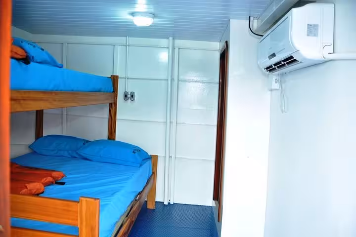 Air-conditioned cabin with bunk beds on Manaus to Belém boat tour, comfortable overnight Amazon river cruise