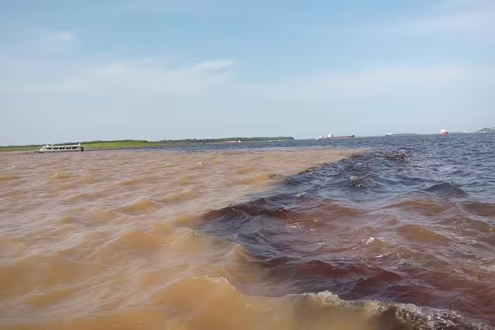 Stunning view of the meeting of waters at the Amazon River, showcasing the natural beauty of the Amazon jungle.
