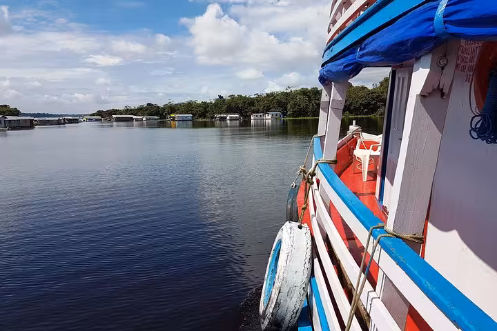 Amazon riverboat cruising from Manaus to Santarém, Brazil, with calm river scenery and floating homes ahead
