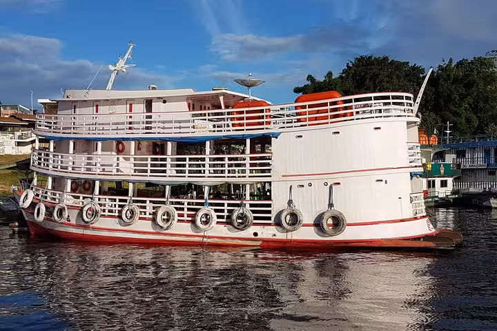 Amazon riverboat for Manaus to Tabatinga trip, private cabin ferry with decks and life rings at port