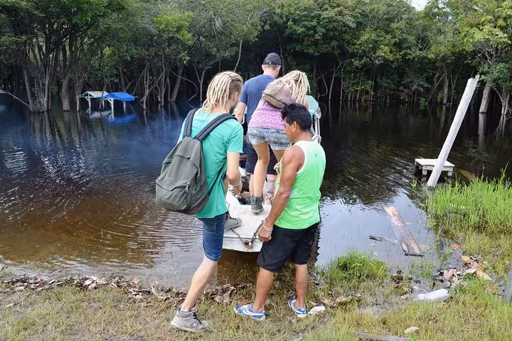 Travelers boarding Amazon speed boat at Santa Rosa border dock for Peru river transfer to Iquitos