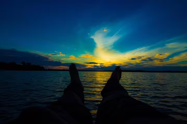 Relaxing in a hammock with a stunning Amazon sunset over the river on a 5-day Amazon Survival Tour.