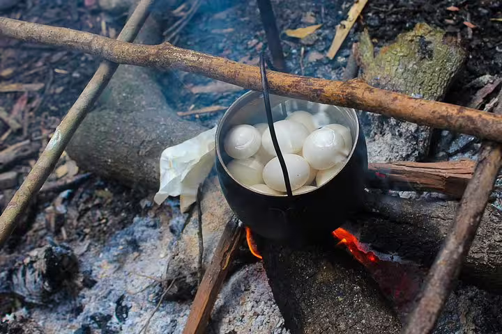 Cooking eggs over an open fire in the Amazon rainforest during the 5-day survival tour experience.