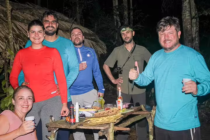 Group of adventurers enjoying a night in the Amazon jungle, showcasing camaraderie on the Amazon Survival Tour 5D/4N.