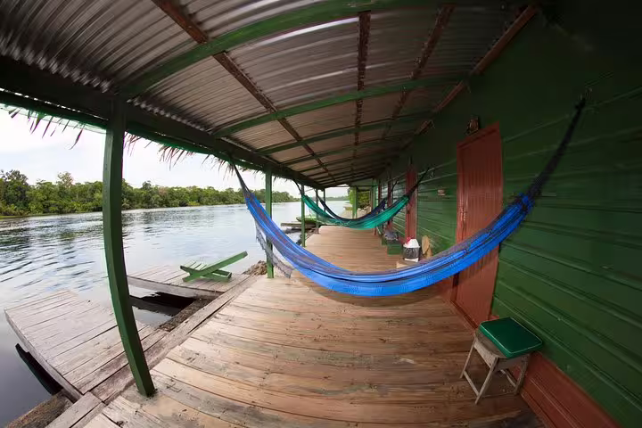 Relaxing hammocks on the deck of Amazon Tapiri Floating Lodge with serene river views in the Amazon jungle.