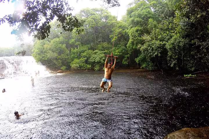 Adventure swing over river by Amazon waterfalls in Presidente Figueiredo, popular day trip from Manaus