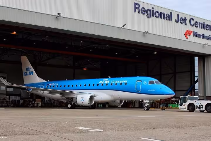 KLM Cityhopper jet at Amsterdam Schiphol, VIP airport departure transfer with private chauffeur to terminal