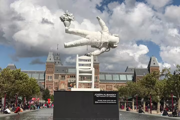 Floating astronaut sculpture at Museumplein by Rijksmuseum, ideal for Your Own Amsterdam random adventure tour