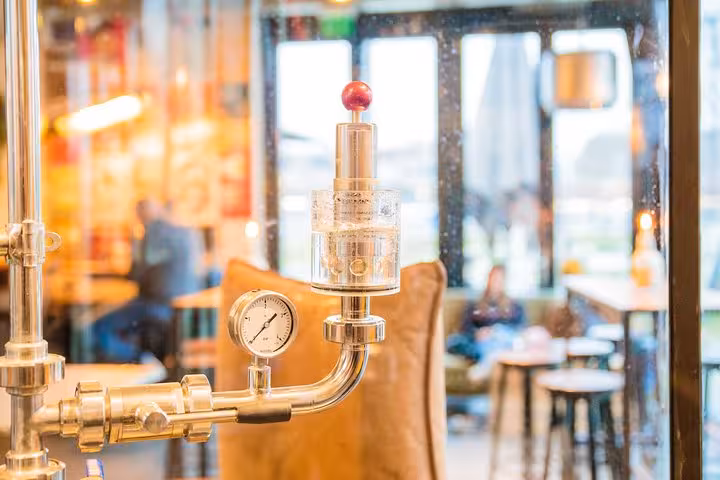 Close-up of brewery valve and pressure gauge at Amsterdam craft beer tour tasting stop by bus
