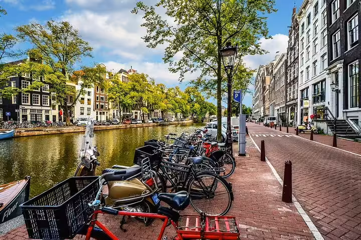 Amsterdam canal street with parked bicycles and historic houses, scenic stop on private Amsterdam to Rotterdam tour