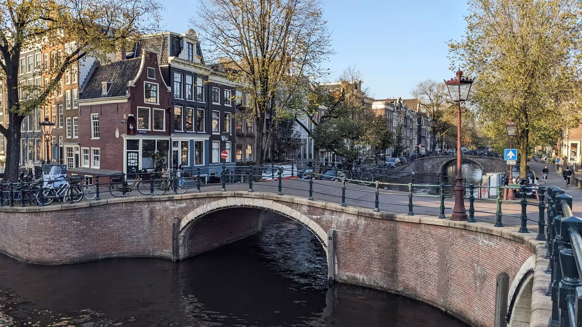 Beautiful scenery of canal with bridges and canal houses in Amsterdam.