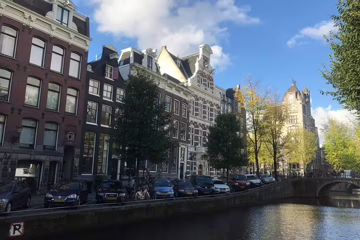Amsterdam canal houses along a historic old city waterway on a private walking tour route