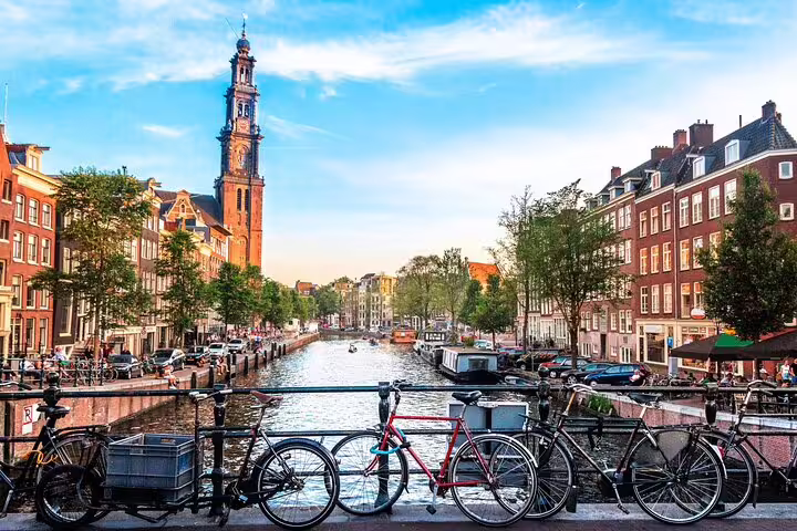 Bicycles on a canal bridge in Amsterdam's Jordaan district with Westerkerk tower in background