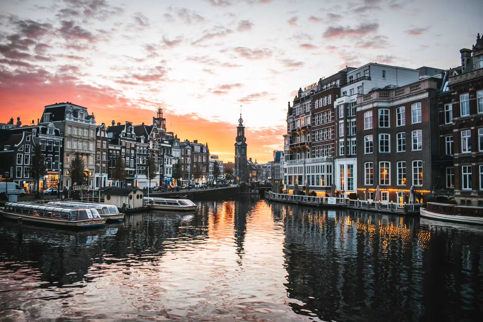 Amsterdam canal sunset near Munttoren, ideal stop on a private layover tour from Schiphol Airport (3–5h)