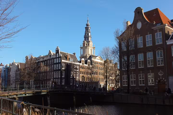 Amsterdam canal houses and Westerkerk tower on a sunny day, private city walking tour with a local guide