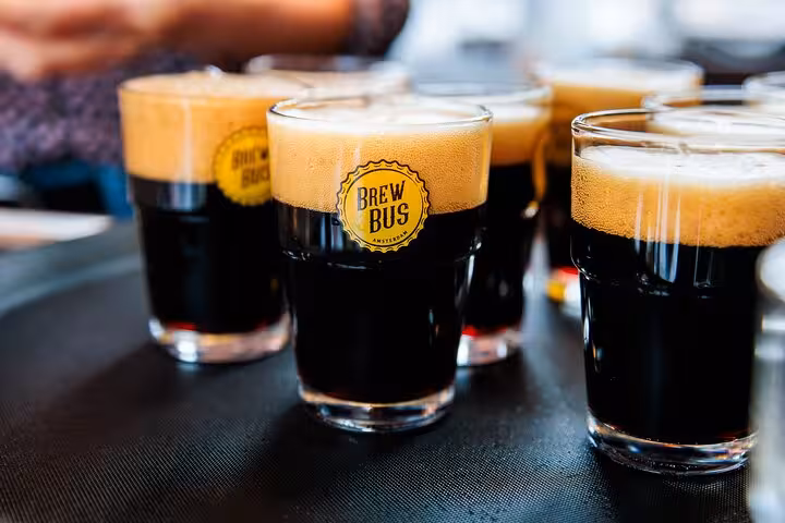 Dark craft beer flights in Amsterdam at Brew Bus tasting, part of guided beer tour with cheese and sausage