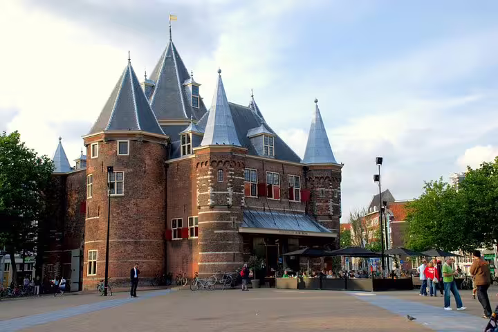 De Waag medieval castle building on Nieuwmarkt square in Amsterdam with tourists