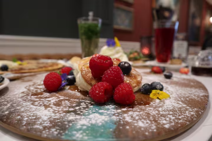 Delicious Dutch pancakes topped with fresh berries and powdered sugar, featured on an Amsterdam walking tour with lunch.
