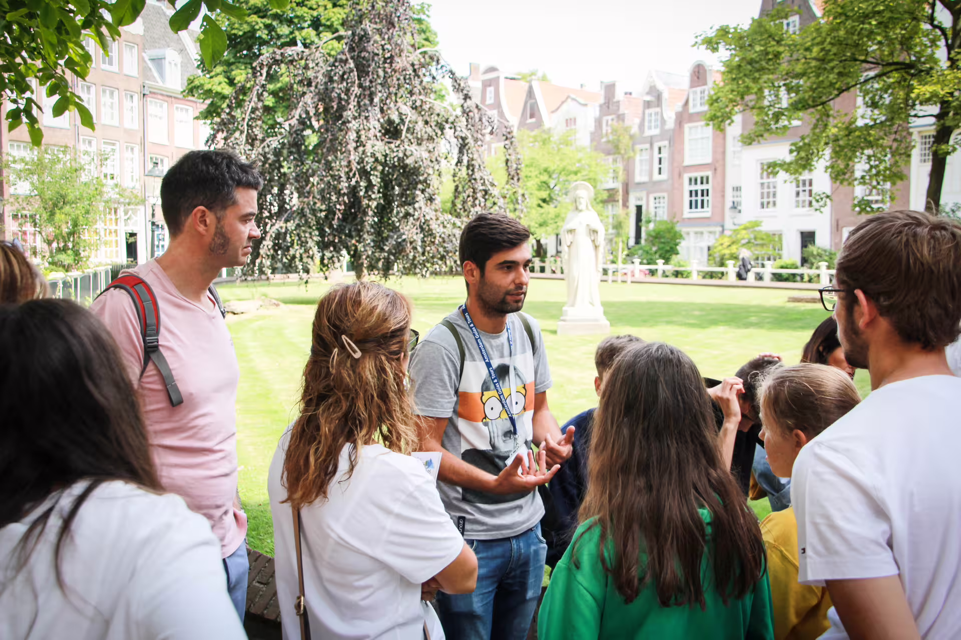 Group of tourists enjoying a guided walking tour in Amsterdam, exploring historic sites and hidden gems with an expert guide.