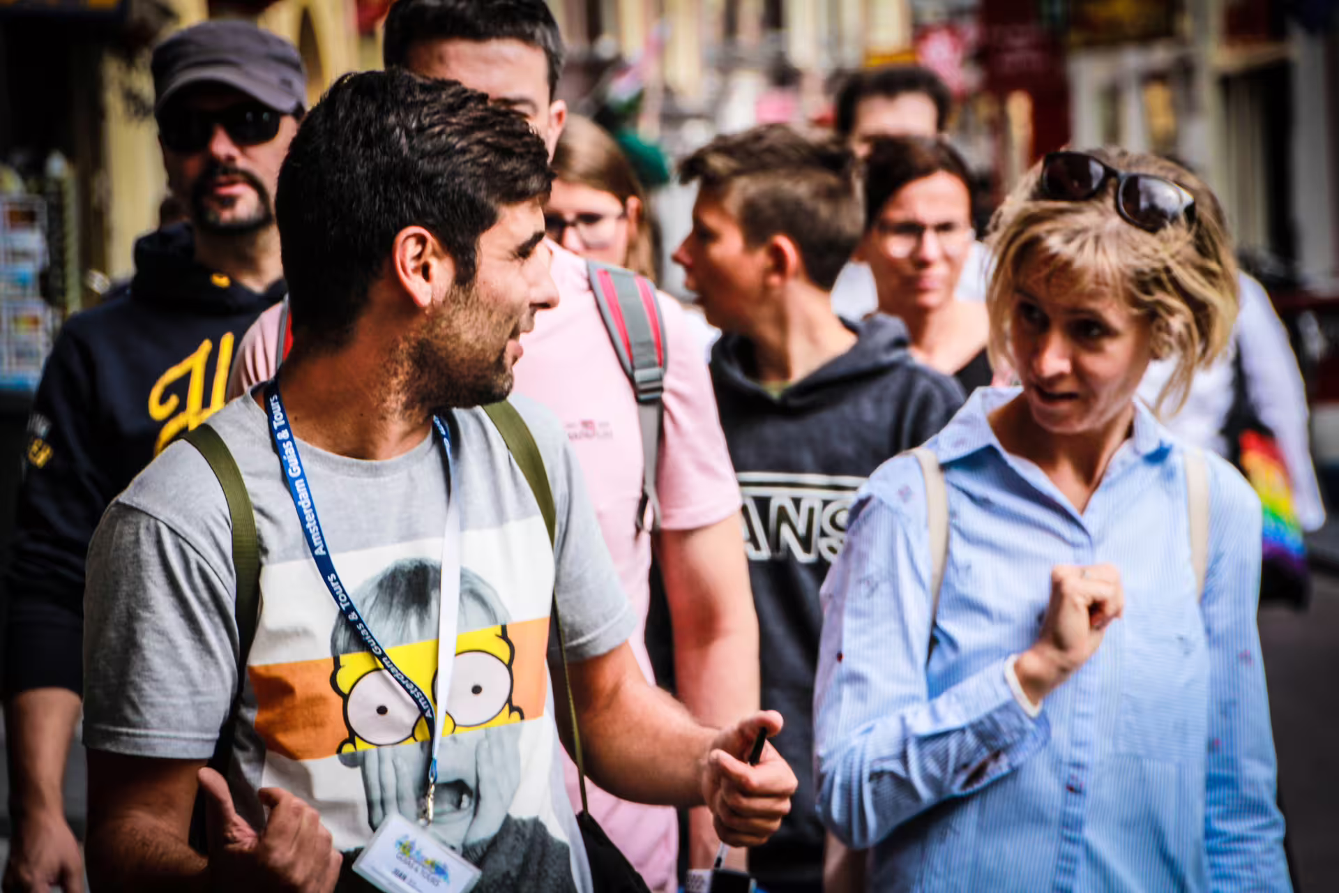 Group of tourists enjoying a guided walking tour in Amsterdam, exploring vibrant streets and local attractions.