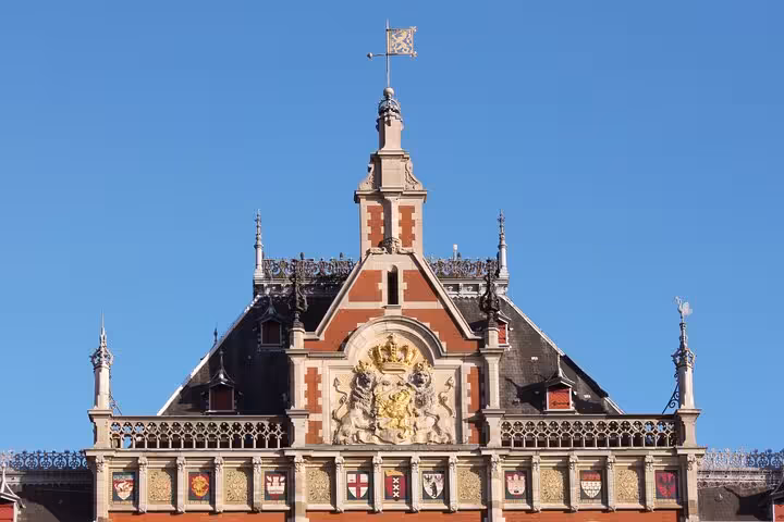 Historic Amsterdam landmark facade under blue sky, featured stop on a private city walking tour with a local