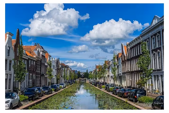 Dutch canal street view near Amsterdam, scenic drive on private tour to Kinderdijk windmills, Gouda and Muiderslot