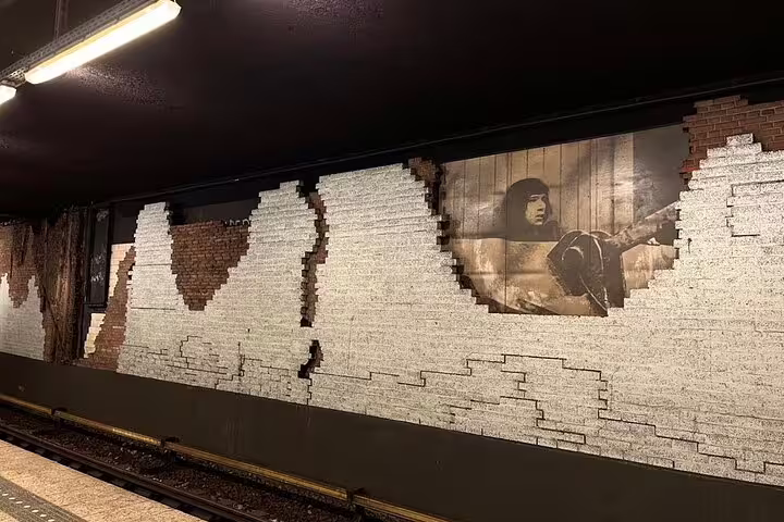 Bricked wall mosaic with vintage portrait in an Amsterdam metro station, seen on Your Own Amsterdam Art Underground