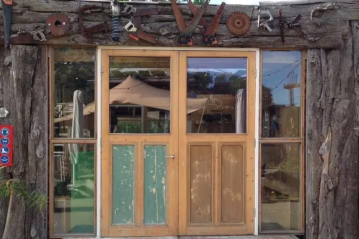 Rustic wooden facade with vintage tools, a quirky stop on a private Amsterdam Noord bike tour