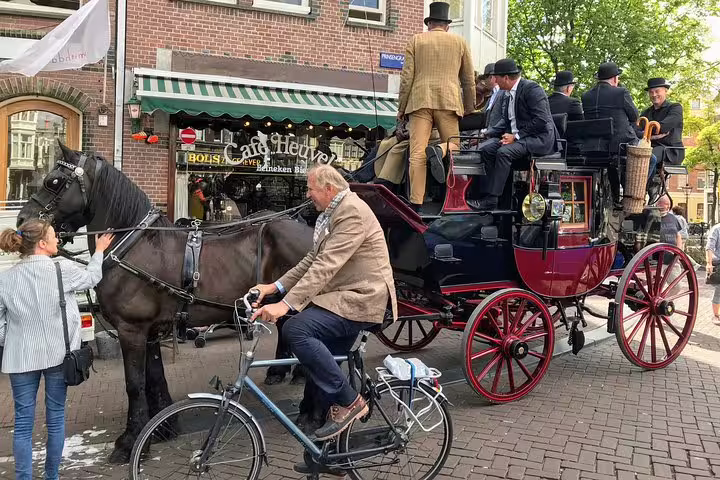 Traditional carriage and bicycles in Amsterdam old town, authentic street scene on private tour