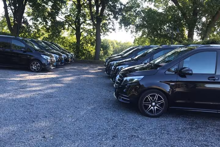 Fleet of executive Mercedes vans for Amsterdam to Schiphol Airport transfers, reliable chauffeur service