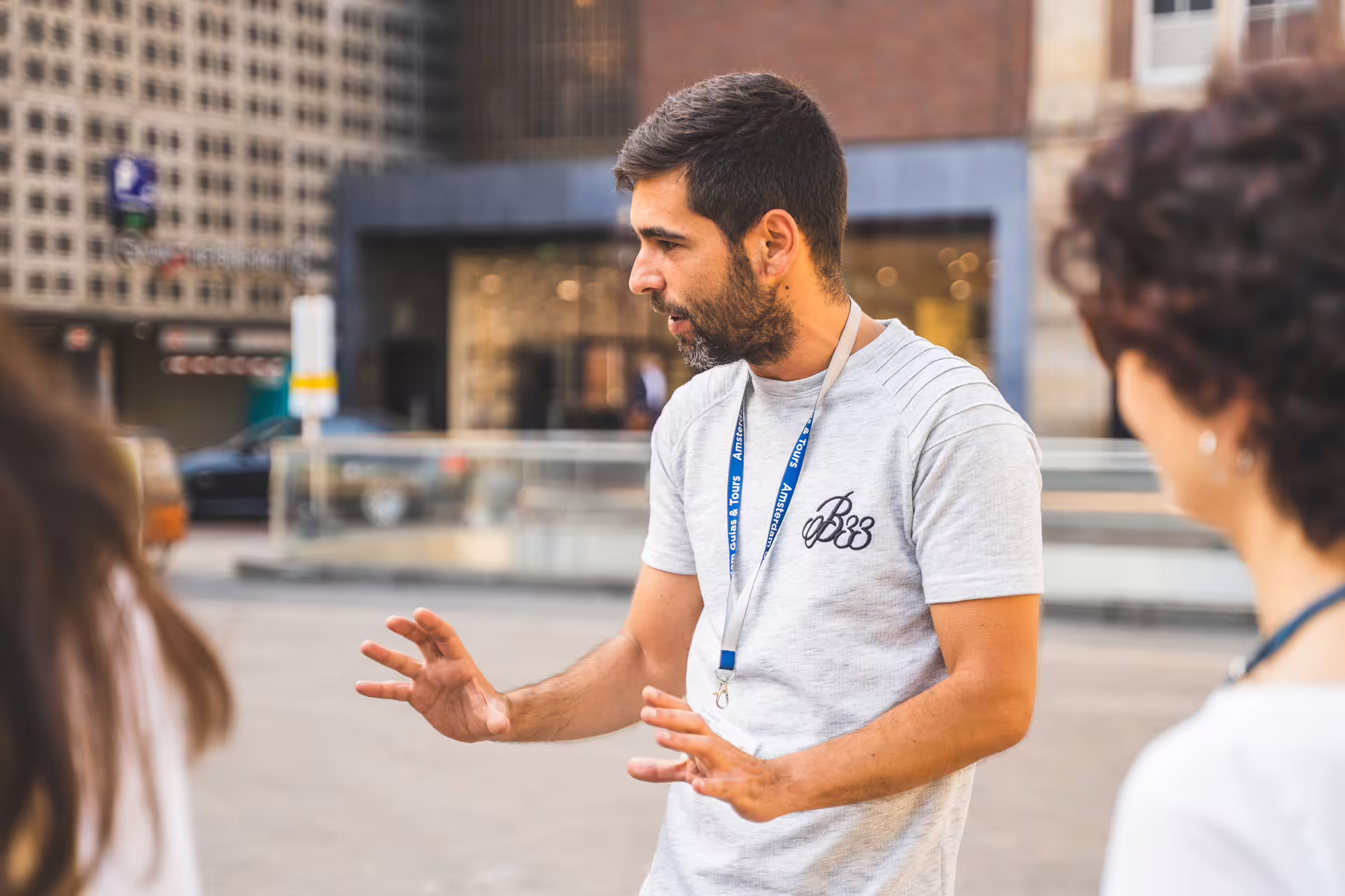 Tour guide leading a group through Amsterdam's historic streets, highlighting the city's rich culture and architecture.