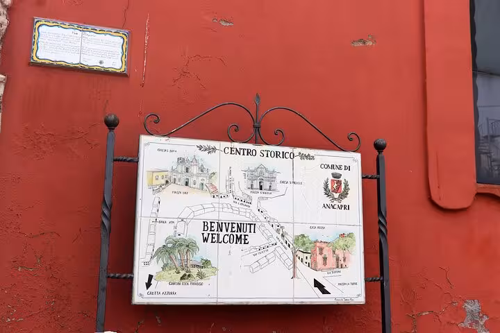 Illustrated map sign of Anacapri's Centro Storico, highlighting key attractions and a warm welcome message.