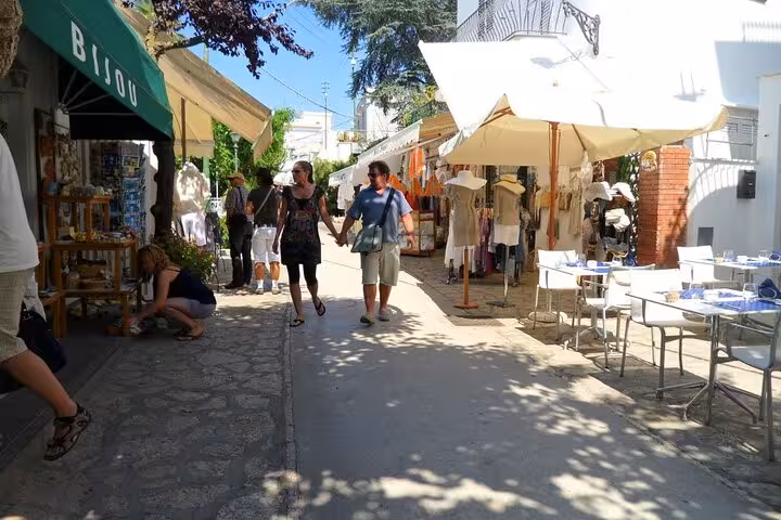 Visitors exploring charming shops and cafes in Anacapri's lively streets on the Capri & Anacapri full-day tour.